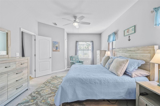 bedroom featuring light carpet, visible vents, ceiling fan, and baseboards