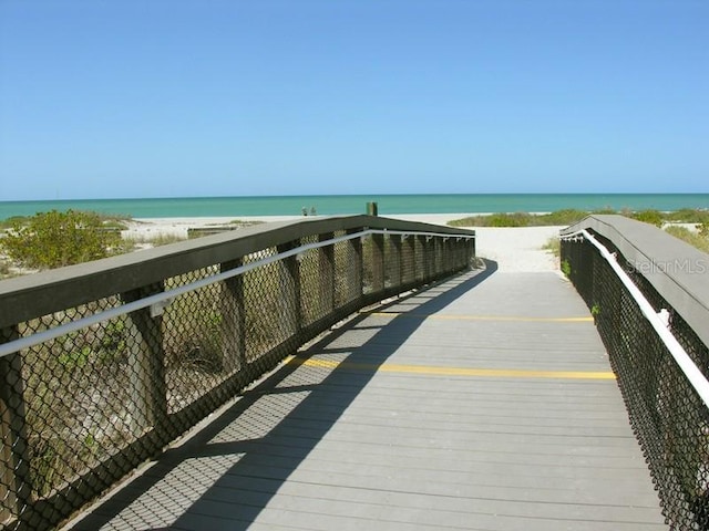 view of property's community with a water view and a view of the beach