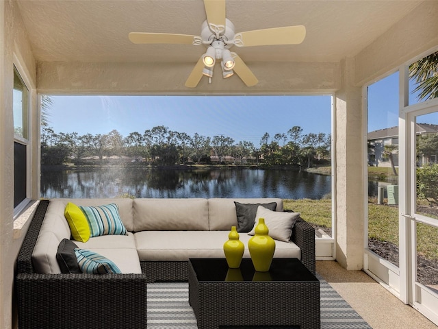 sunroom with a water view and ceiling fan