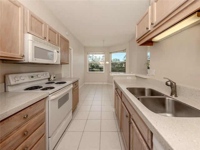 kitchen featuring sink, white appliances, light brown cabinetry, and light tile patterned floors