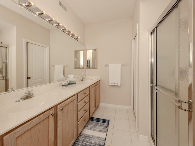 bathroom featuring a shower with door, tile patterned flooring, and vanity