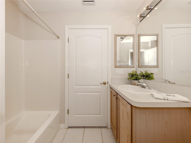 bathroom featuring vanity, tile patterned floors, and shower / washtub combination