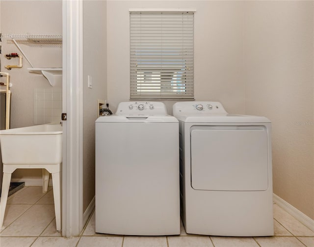 washroom featuring light tile patterned floors and washing machine and clothes dryer