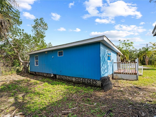 view of home's exterior with a wooden deck