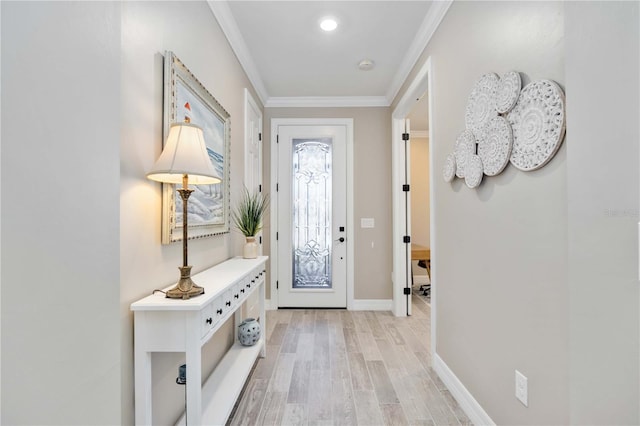 foyer featuring light hardwood / wood-style floors and crown molding