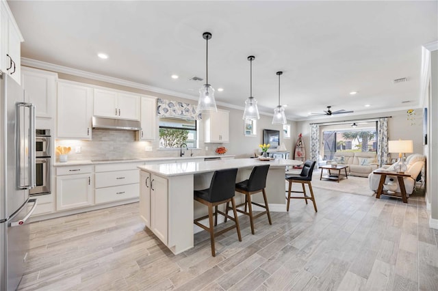 kitchen featuring white cabinetry, ceiling fan, and a kitchen island