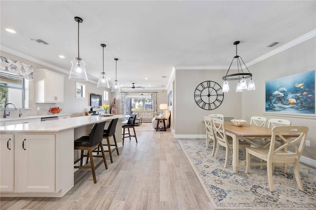 kitchen featuring a center island, decorative light fixtures, white cabinetry, and ceiling fan