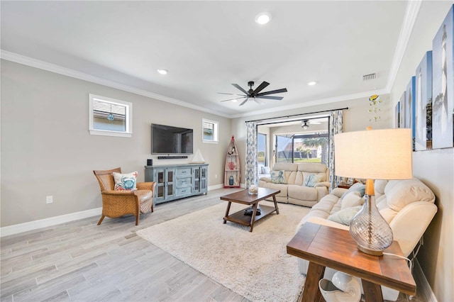 living room featuring ceiling fan, crown molding, and light hardwood / wood-style flooring