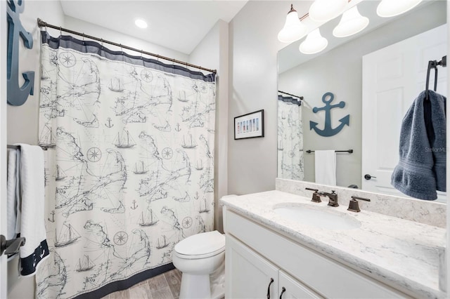 bathroom featuring wood-type flooring, vanity, toilet, and a shower with curtain