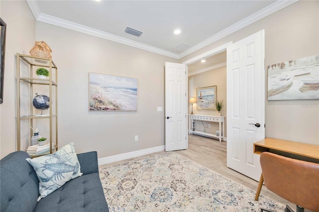 living area featuring light hardwood / wood-style flooring and ornamental molding