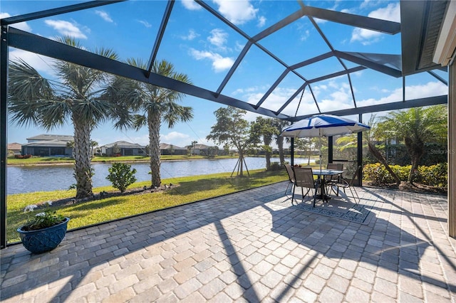 view of patio / terrace with a lanai and a water view