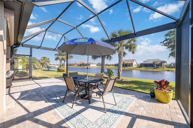 view of patio / terrace featuring a lanai and a water view