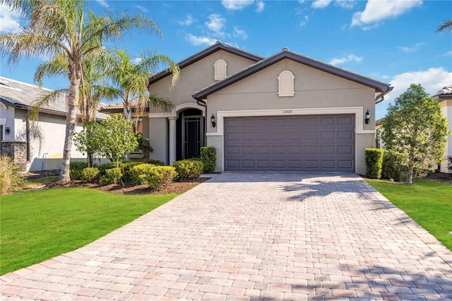 view of front of home with a front lawn and a garage