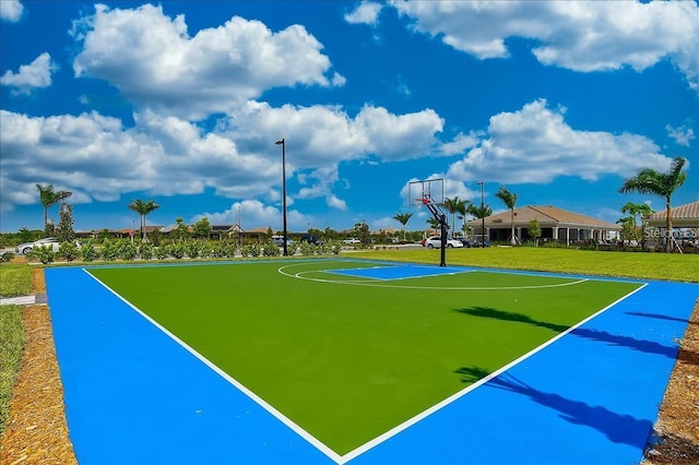 view of basketball court with a yard