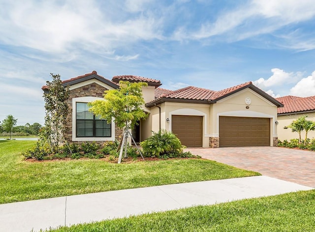 mediterranean / spanish-style house with a front yard and a garage