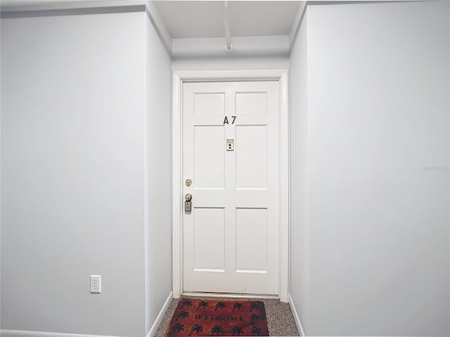 doorway with carpet flooring