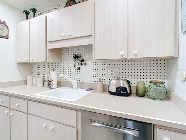 kitchen with dishwasher, sink, and tasteful backsplash