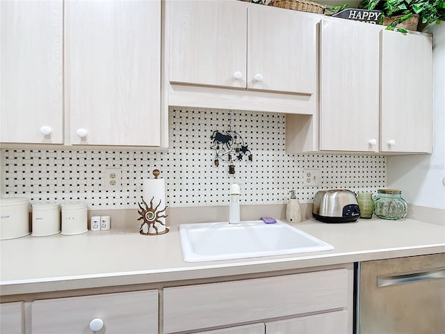 kitchen featuring backsplash, dishwasher, light brown cabinets, and sink