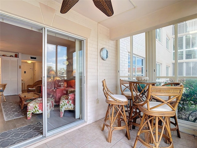 sunroom / solarium with ceiling fan