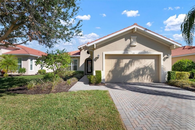 view of front of property featuring a garage and a front lawn