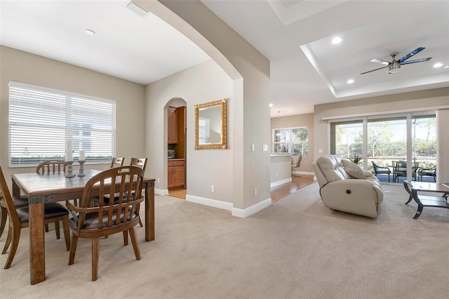 carpeted dining space featuring ceiling fan