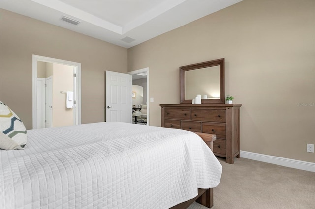 carpeted bedroom featuring ensuite bathroom