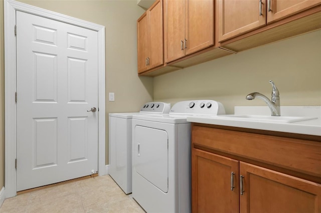 laundry area featuring sink, cabinets, separate washer and dryer, and light tile patterned flooring