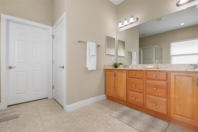 bathroom featuring walk in shower, tile patterned flooring, and vanity