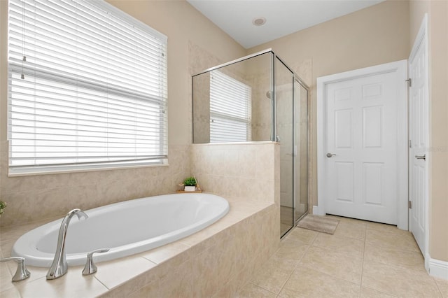 bathroom with independent shower and bath and tile patterned flooring