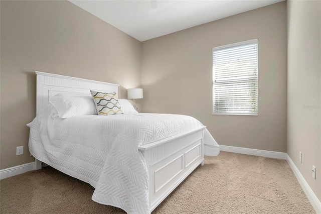 bedroom featuring light colored carpet and ceiling fan