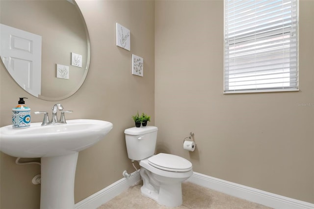 bathroom with toilet and tile patterned floors