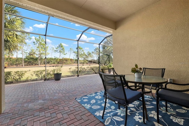 view of patio / terrace featuring glass enclosure