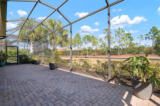 view of patio with glass enclosure