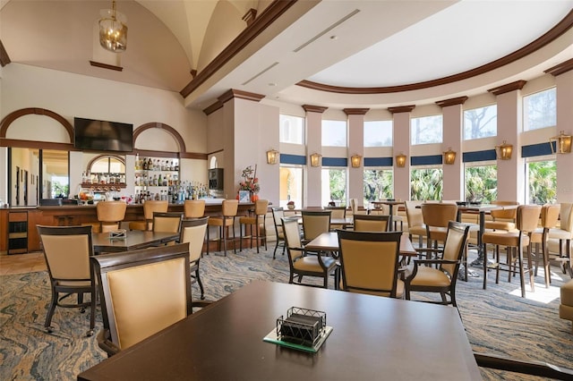 dining room with a high ceiling and indoor bar