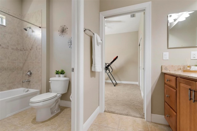 full bathroom featuring vanity, toilet, tiled shower / bath combo, and tile patterned flooring