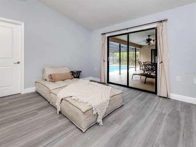 bedroom featuring access to exterior and light hardwood / wood-style floors