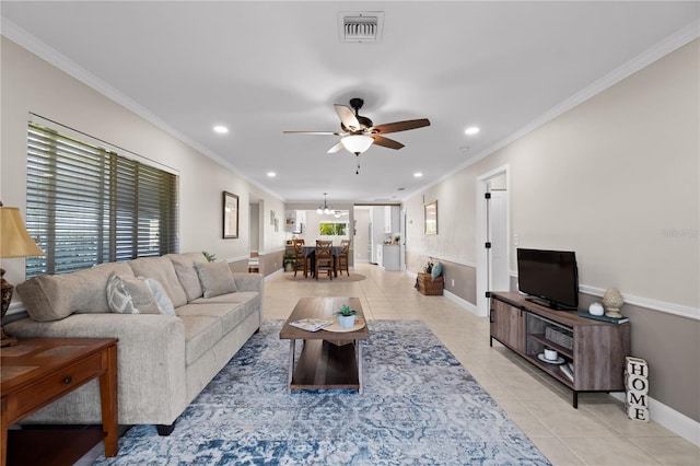 living room with crown molding, light tile patterned floors, and ceiling fan with notable chandelier