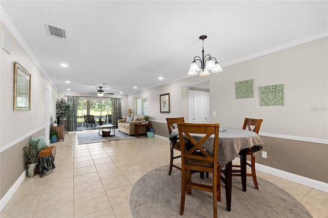 tiled dining area with ceiling fan with notable chandelier and crown molding