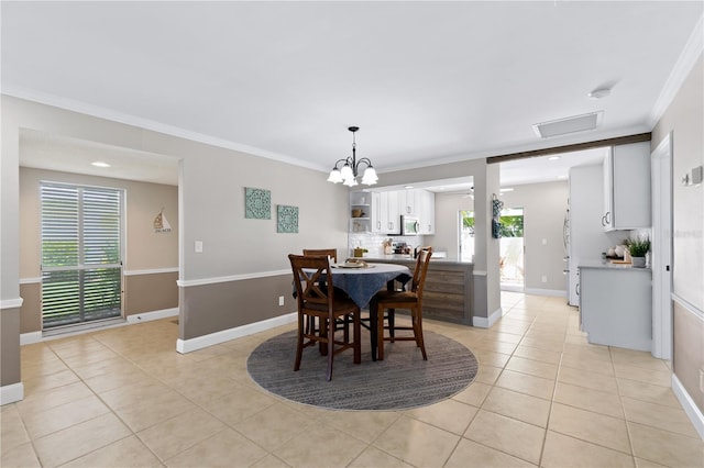 tiled dining room with ornamental molding and an inviting chandelier