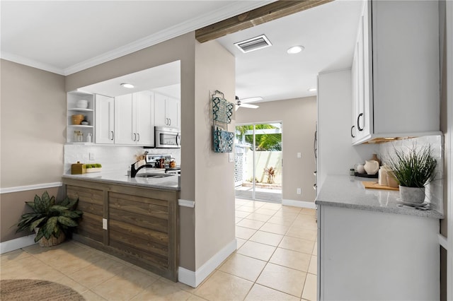 kitchen featuring white cabinets, sink, decorative backsplash, light stone countertops, and light tile patterned flooring