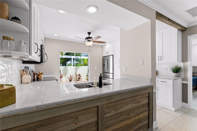 kitchen featuring stainless steel fridge with ice dispenser, white cabinets, and light stone countertops