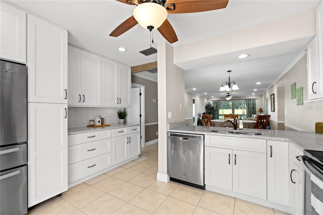 kitchen featuring light stone countertops, sink, stainless steel appliances, white cabinets, and light tile patterned flooring