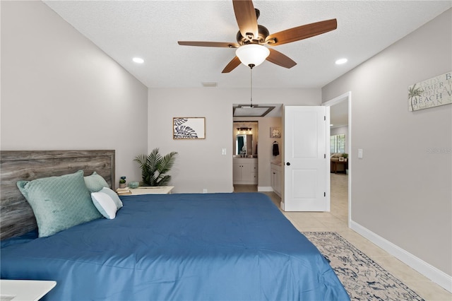 tiled bedroom with a textured ceiling, connected bathroom, and ceiling fan