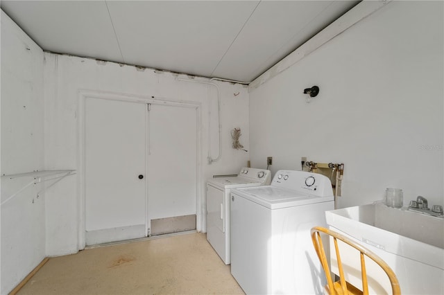 laundry room with independent washer and dryer and sink