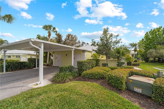 single story home with a front lawn and a carport