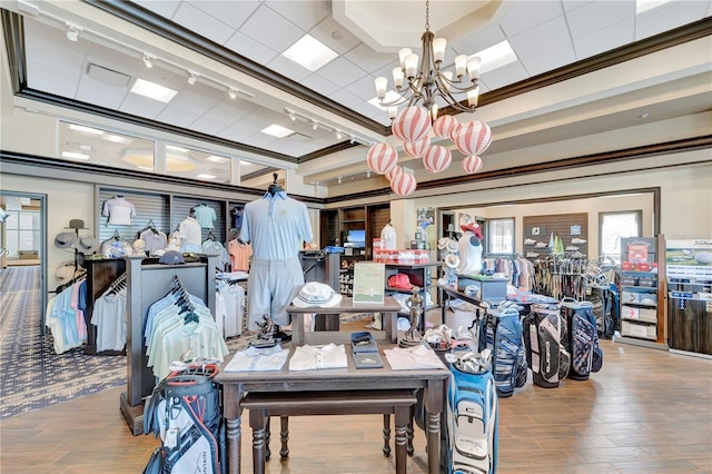 interior space with crown molding, hardwood / wood-style floors, and a notable chandelier