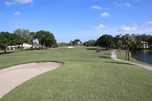 surrounding community featuring a yard and a water view