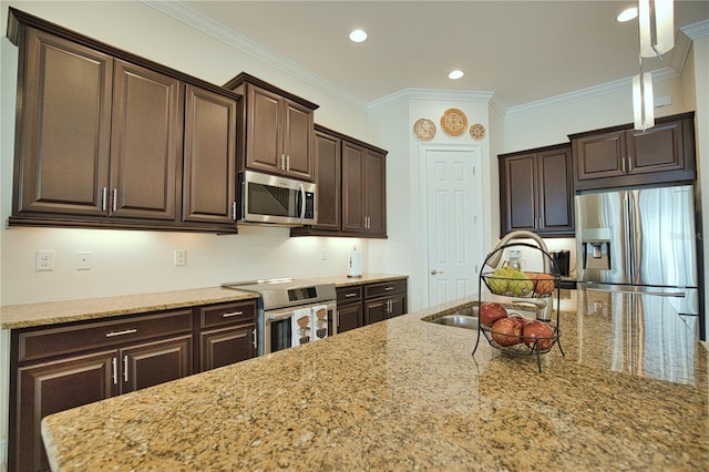 kitchen with light stone countertops, sink, hanging light fixtures, crown molding, and appliances with stainless steel finishes