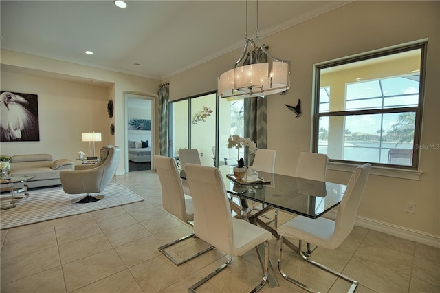 tiled dining space with a water view and ornamental molding