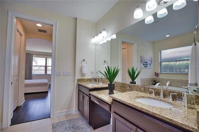 bathroom featuring tile patterned flooring, vanity, and a notable chandelier